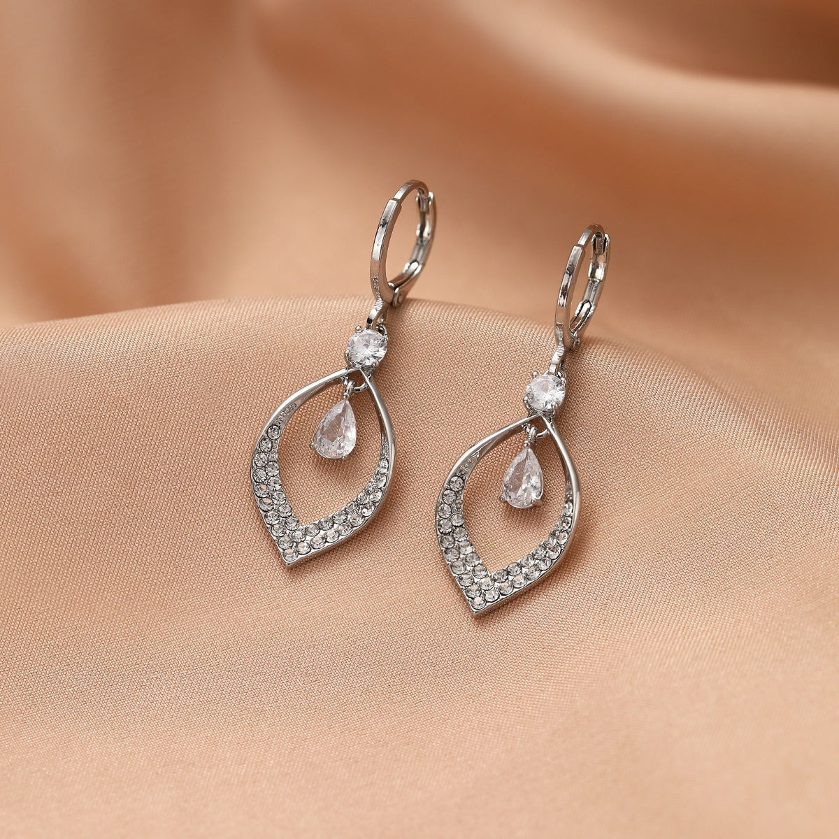 A Woman With Elegant Zircon Water Drop Tassel Earrings